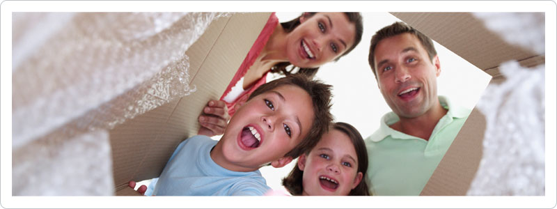Family packing a box for a move